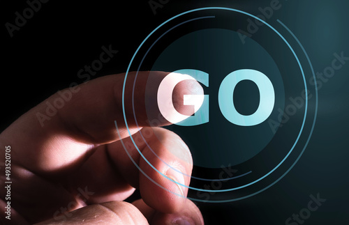 Hand pressing GO button on virtual screen. go programming language. 