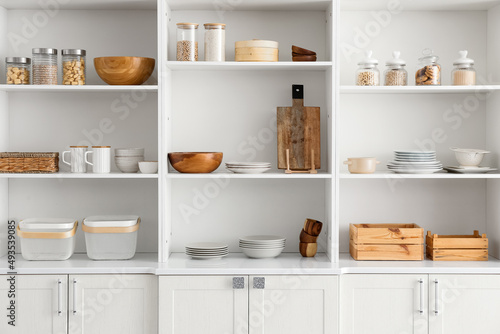 Shelf unit with clean dishware in kitchen