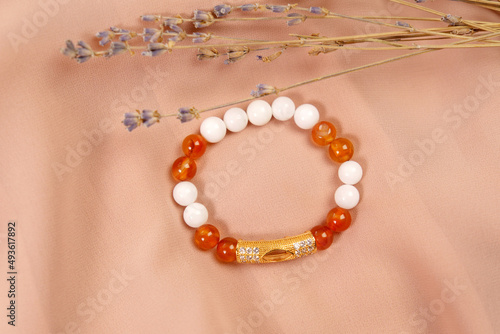 Costume jewelry on agate and carnelian fabric, copy space. E-commerce, online sales and social networks.