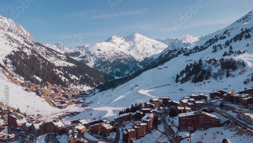 Aerial panorama of Meribel village, on the end of the valley in the french Alps. Beautiful panorama of ski slopes and chalets with alpine background.