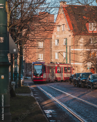 A tram going through the streets of Nowy Port in Gdańsk on a sunny morning.