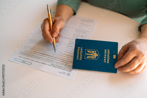 PESEL. National identification number in Poland. Polish ID. Official personal document.Woman hand write with a pen in PESEL document on white table