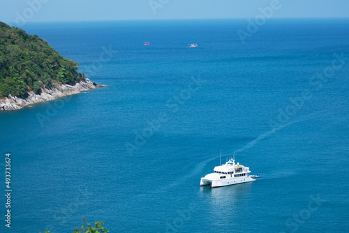 Aerial View of Yacht boat or sailboat luxury boat in tropical summer sea. Transportation and travel background Beautiful sea in summer season at Phuket island Thailand