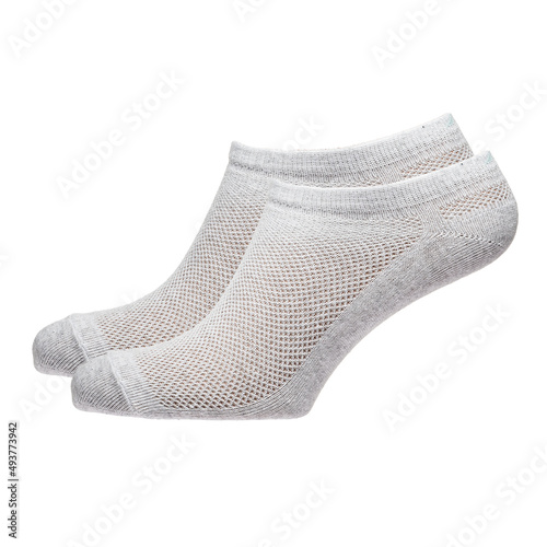 A pair of fabric socks stands on a white isolated background. Volumetric socks on a transparent mannequin.
