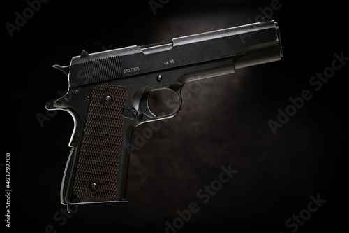 Colt 1911 pistol on the black background.