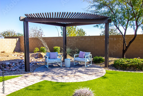 Back Yard Pergola With Two Arm Chairs On Pavers