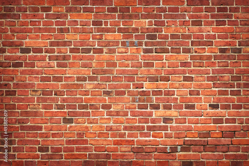 Fragment of an old red brick wall. Grunge textured background