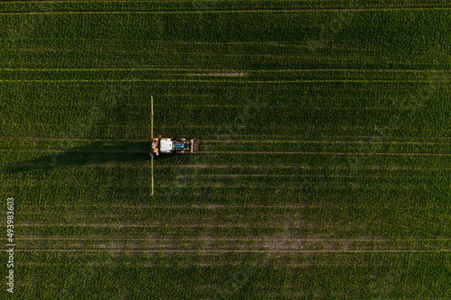 Tractor spraying fertilizer on a agriculture field. Chemical treatment of the crop in Finland.