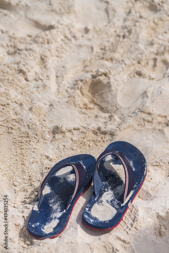 Pair of blue sandals at the beach. Leisure concept