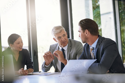 They know the can trust his opinion. Shot of a team of businesspeople meeting at a table in the boardroom.