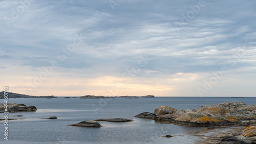 View of the archipelago in northern Gothenburg, Öckerö, Sweden. Cloudy sky and sea, nice cliffs in the foreground. A nice summer day in Sweden. Place for text, copy space.