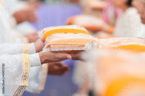 People give monk cloth in Thai ordination ceremony