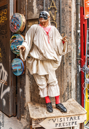Naples, Italy - june 29 2021: Pulcinella traditional Neapolitan theater mask in San Gregorio Armeno street, historic center of Naples city and the famous street of the cribs