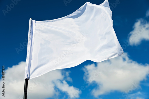 White flag flying against blue sky