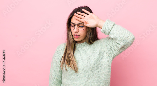 pretty hispanic woman looking stressed, tired and frustrated, drying sweat off forehead, feeling hopeless and exhausted