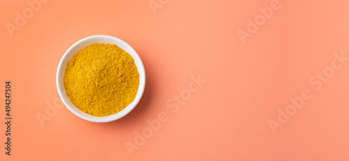 Organic curry yellow powder in the ceramic bowl - Healthy food