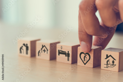 Elderly care concept. Holding wooden cube smart flat design with icon related to elderly care, medical, rehabilitation service, nursing care for enhancing quality of life in elder age. Care banner..