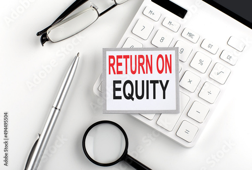 RETURN ON EQUITY text on the sticker with calculator, glasses and magnifier