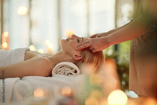 Restore balance to your whole body and mind. Cropped shot of a young woman enjoying a head massage at a spa.