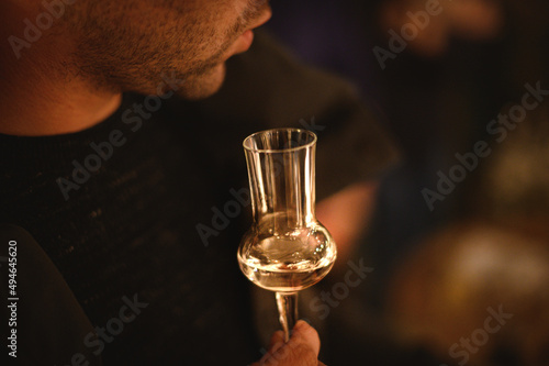 hand with a glass of grappa wine at a tasting