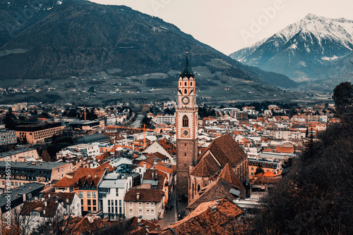 view of the town of merano in the alps at winter