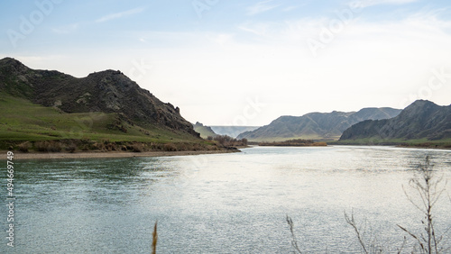 A beautiful wide river between rocks and hills in spring