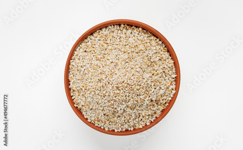 Barley groats in bowls and bags isolated on a white background. High quality photo