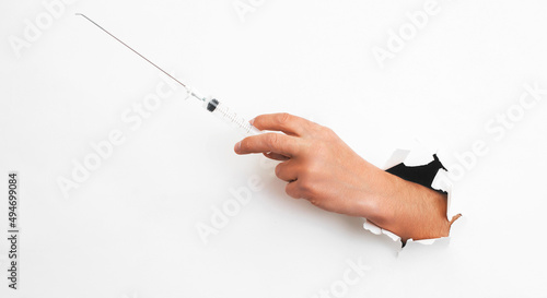 Syringe for intrauterine infections and tonsillectomy in hand on a white background. Syringe for washing the tonsils with nozzles.