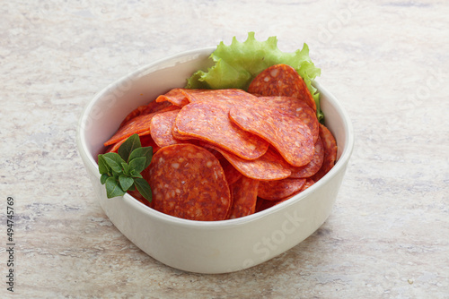 Sliced pepperoni sausage in the bowl