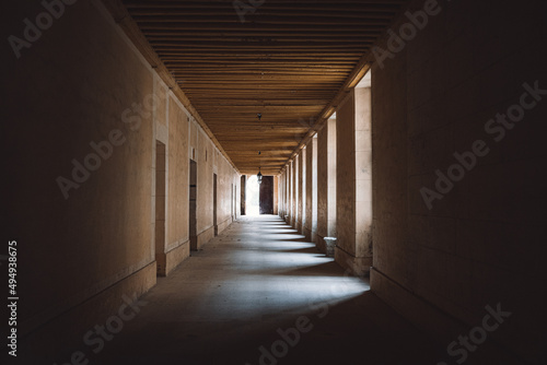 Closeup of a long hallway with lights between columns