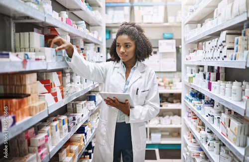 Never fear, your pharmacist is here. Cropped shot of an attractive young female pharmacist working in a pharmacy.