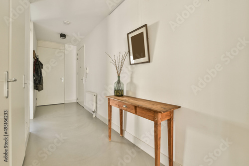 The interior of a narrow corridor i the apartment, in a minimalist style with a cozy design.