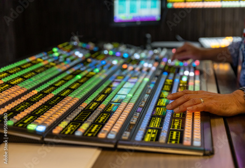 Technicians hands working on a video switcher