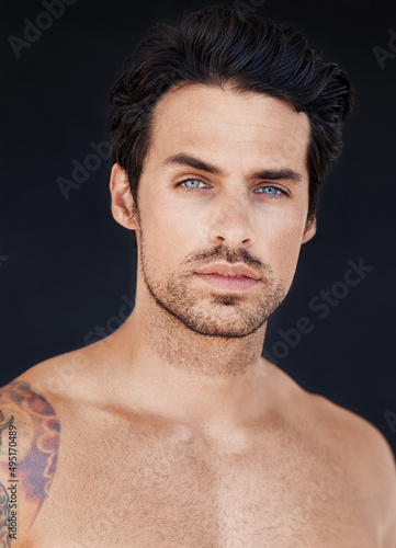 Looking straight through you with those sparkling blue eyes. Portrait of good looking male.