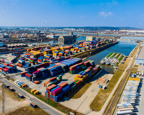 industrial port with containers in Danube river. Many much cargo waitng for shipping in port.