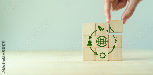 Circular economy concept, recycle, environment, reuse, manufacturing, waste, consumer, resources. LCA Life cycle assessment. Sustainability Wooden cubes; symbol of circular economy on grey background.