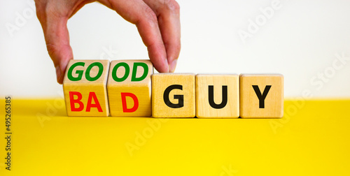 Good or bad guy symbol. Businessman turns cubes and changes concept words Bad guy to Good guy. Beautiful white background. Business psychological good or bad guy concept. Copy space.