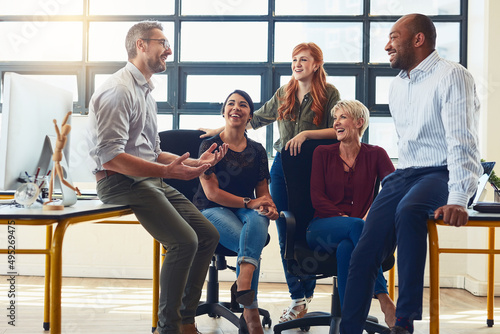 Their dynamic approach is what distinguishes them from the rest. Shot of a group of designers having a discussion in an office.