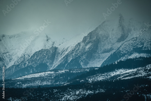 Tatry Wysokie o świcie, zima, szczyty w chmurach, Karpaty, widok z przełęczy nad Łapszanką.