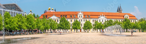 Panoramic view over major square with fountains in Magdeburg by Cathedral and Government Office, at sunny day and blue sky with people enjoying the day.