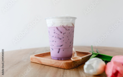 Iced taro tea with milk in a plastic cup
