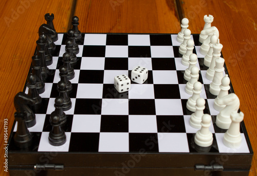 Chessboard and dice. The concept of uncertainty, planning, strategy. Uncertainty and confidence in action.