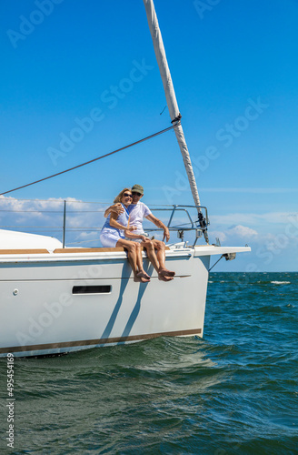 Senior couple relaxing on vacation sailing luxury yacht