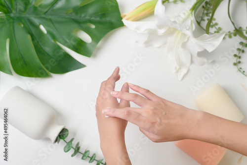 close up hand of applying moisturizing cream, skincare and beauty concept