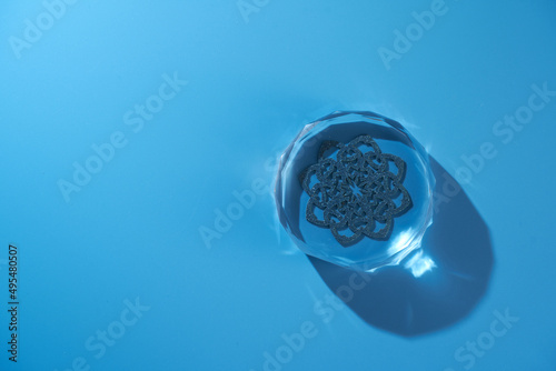 crystal paperweight against blue background