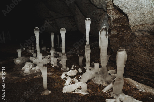 Stalagmite ice in the cave grows on the floor, beauty under the ground, karst cavity, speleology, sinkhole in the ground.