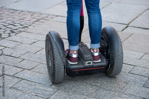 closeup of people standing on segway in the street