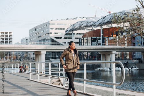 Portrait of a young businesswoman standing on the bridge at the modern residential district in Lyon