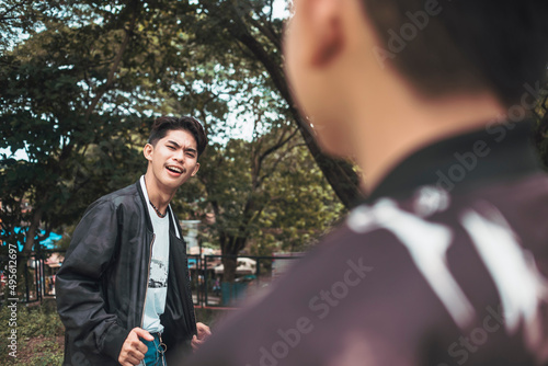 A young boastful man in a confident mood. Cocky about his outfit. Showing his confidence to his friend.