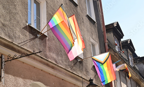 Lgbtq flags hanging at building. LGBT culture symbol. Bright gay flags waving in wind at sunny day